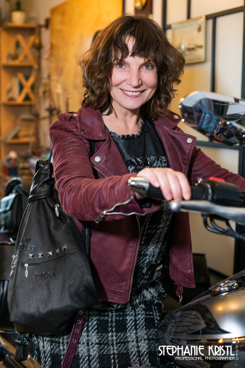 black leather biker backpack with a motor bike