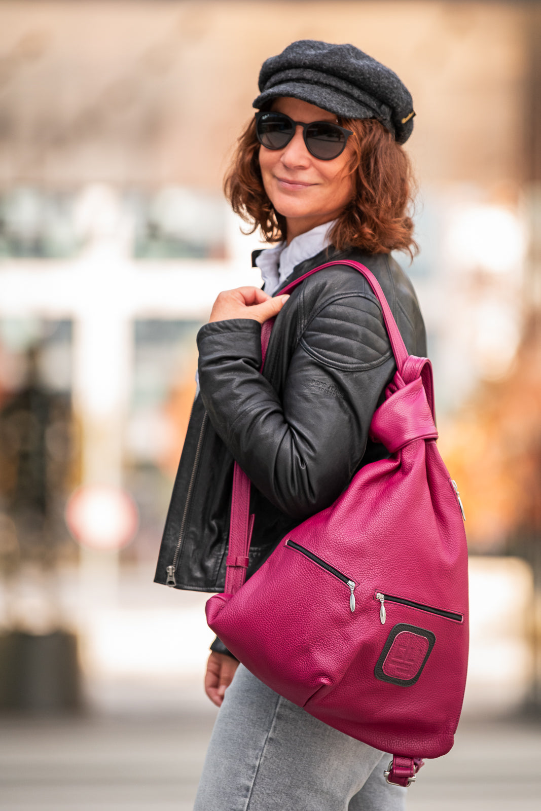 woman with a pink leather bag on her shoulder