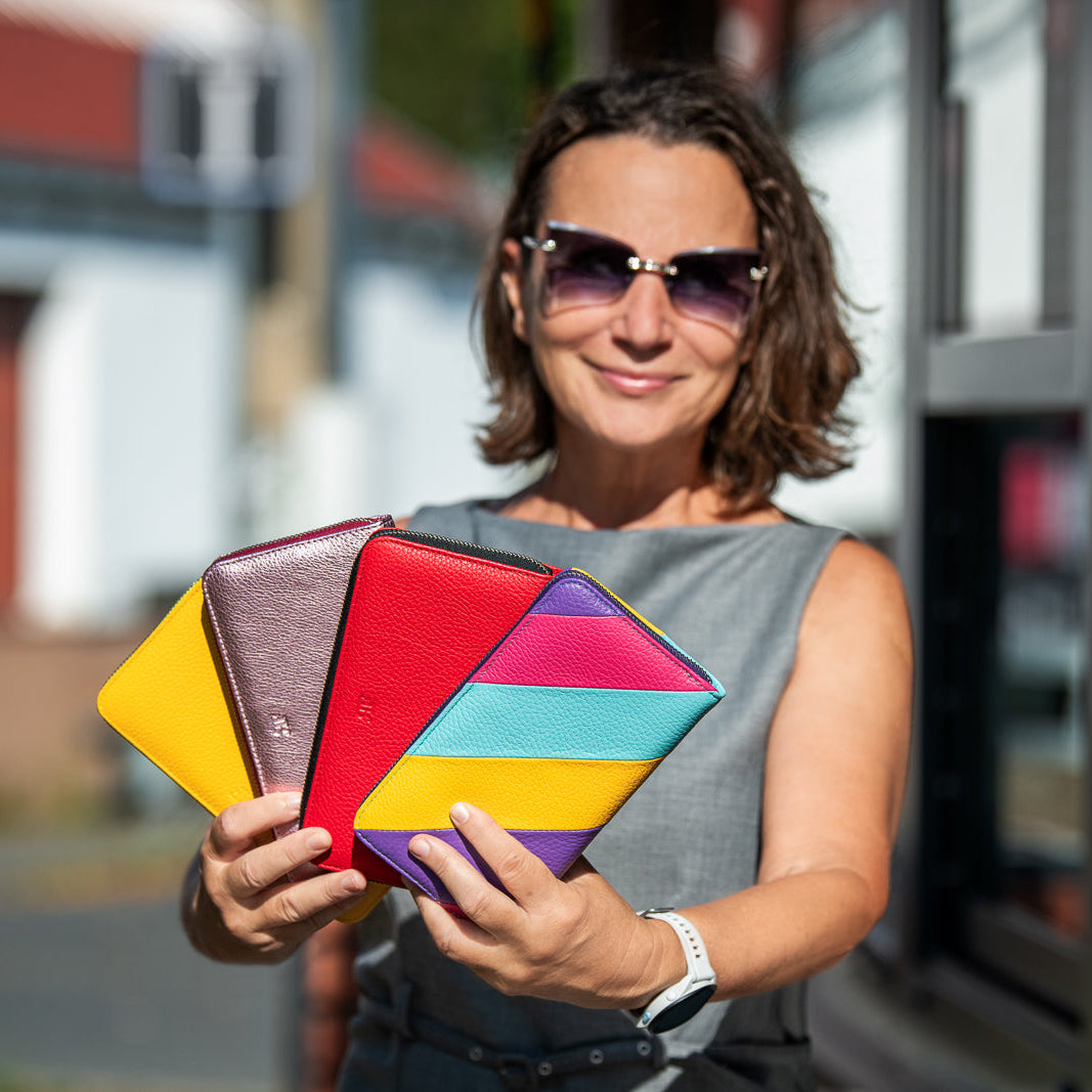 woman with leather wallets in the hands