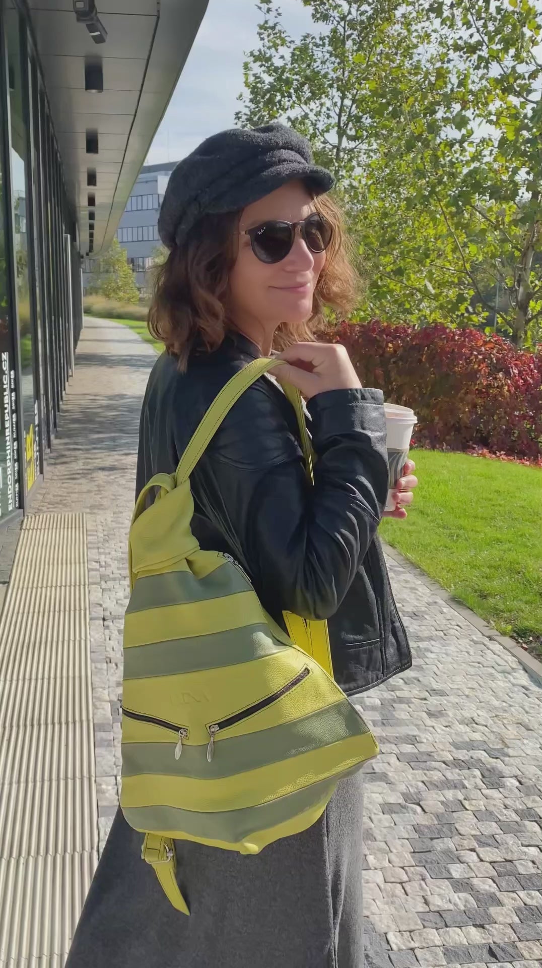 Green leathre backack wearing by woman in the city