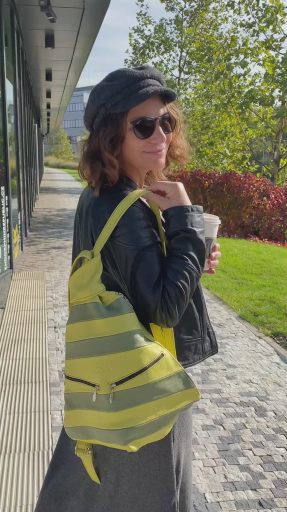 Green leathre backack wearing by woman in the city