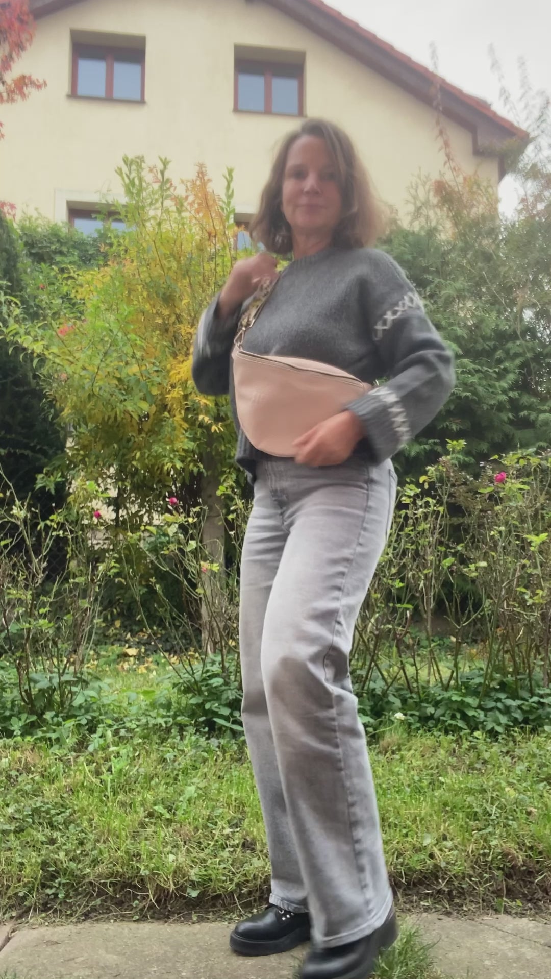 beige leather fanny bag bum bag presented by a woman