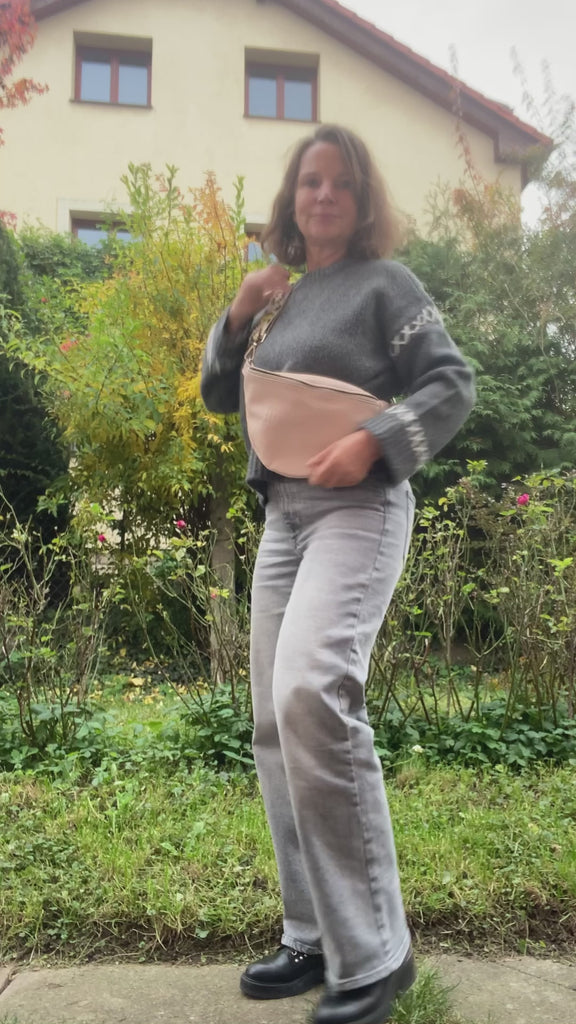 beige leather fanny bag bum bag presented by a woman